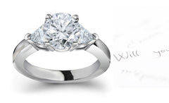 engagement ring three stone with round diamond center and side trillion diamonds