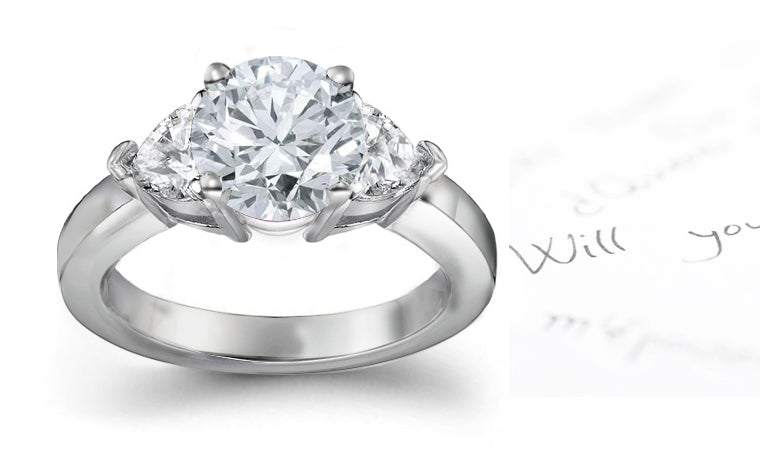 engagement ring with round diamond center and side heart diamonds