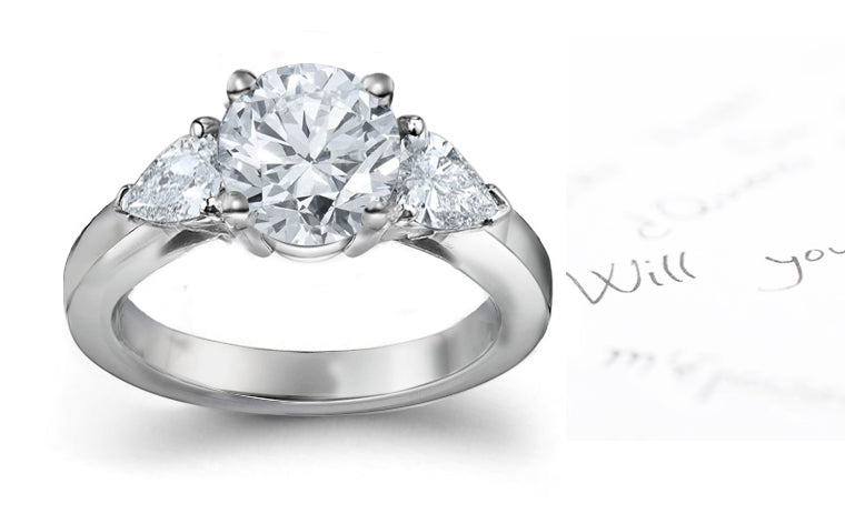 engagement ring with round diamond center and side pear shaped diamonds