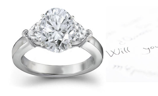 engagement ring with oval diamond center and side heart diamonds