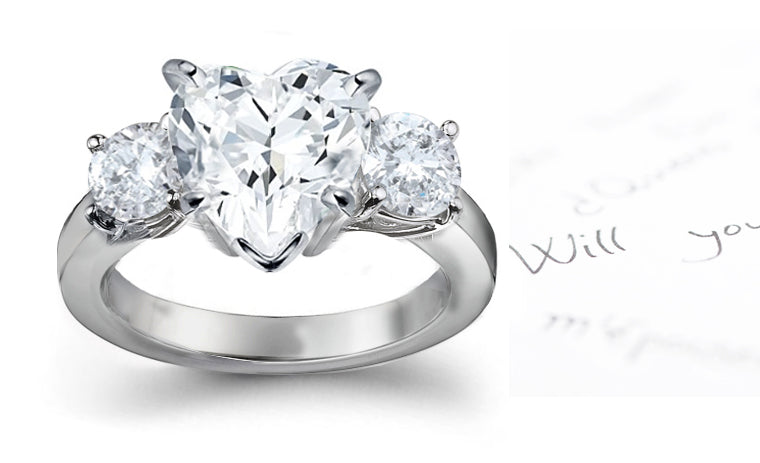 engagement ring with heart diamond center and side round diamonds