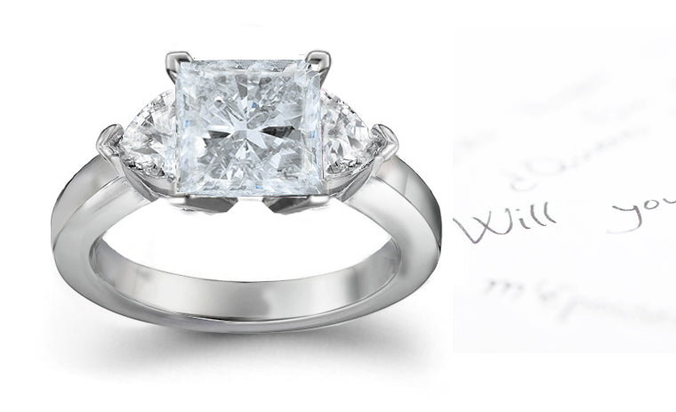 engagement ring with square diamond center and side heart diamonds