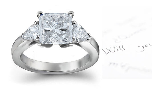 engagement ring with square diamond center and side pear shaped diamonds