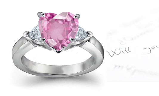 engagement ring with heart pink sapphire center and side trillion diamonds