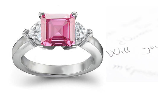 engagement ring with square pink sapphire center and side heart diamonds