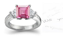 engagement ring with square pink sapphire center and side heart diamonds