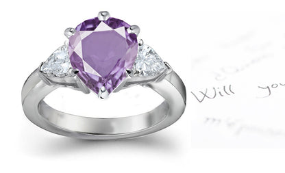 engagement ring with pear purple sapphire center stone and side pear diamonds