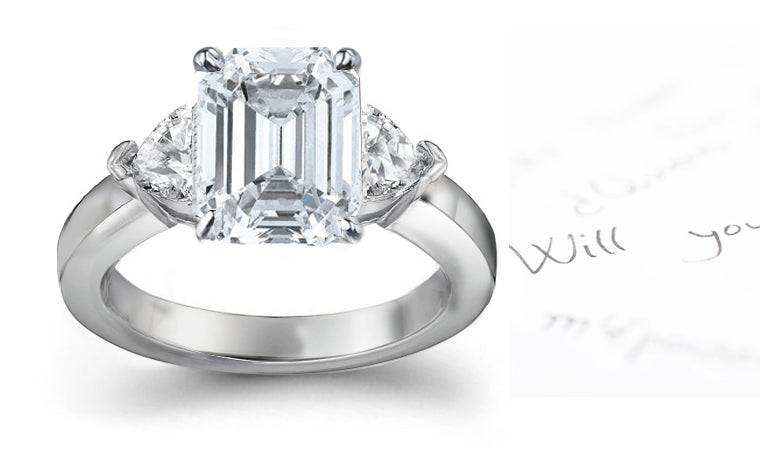 engagement ring three stone with emerald cut diamond center and side trillion diamonds