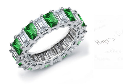 eternity ring prong set with emerald cut emeralds and diamonds