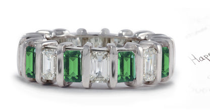 eternity ring handcrafted with bar set emerald cut emeralds and diamonds