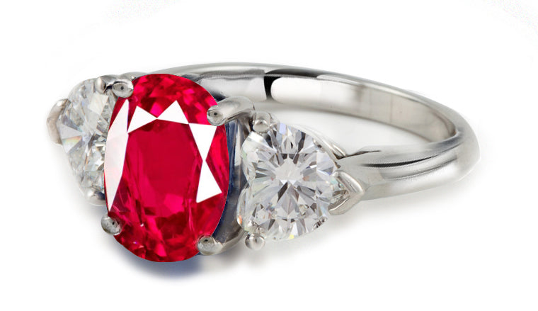 engagement ring three stone with oval ruby center and side heart diamonds