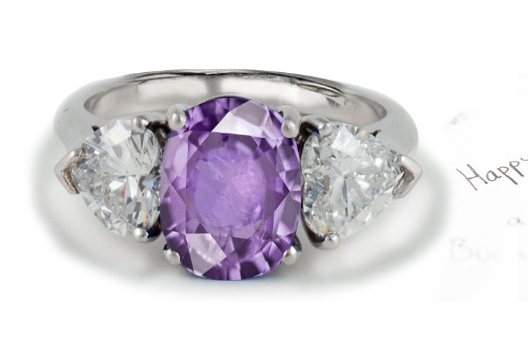 engagement ring three stone with oval purple sapphire center and side heart diamonds