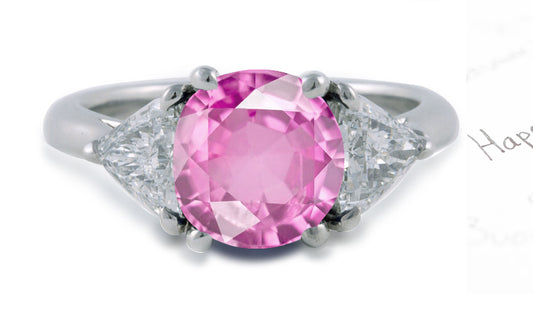 engagement ring three stone with oval pink sapphire center and side trillion diamonds