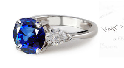 engagement ring three stone with round blue sapphire and trillion diamonds