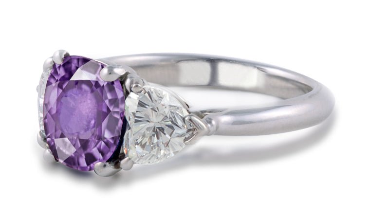 engagement ring three stone with oval purple sapphire center and side heart diamonds