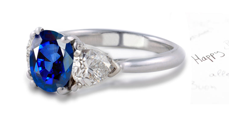 engagement ring three stone with oval blue sapphire and side pear diamonds