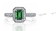 engagement ring handcrafted with emerald cut emerald center and diamond halo/band