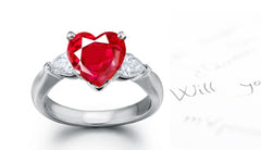 engagement ring three stone with heart ruby center and side pear diamonds