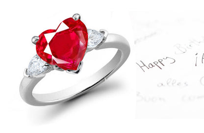 engagement ring three stone with heart ruby center and side pear diamonds