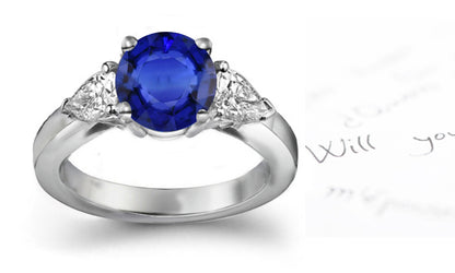 engagement ring three stone with oval blue sapphire and side pear shape diamonds