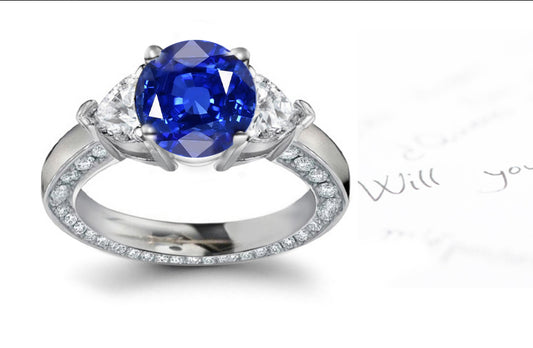 engagement ring with round blue sapphire center and heart/round diamond accents band