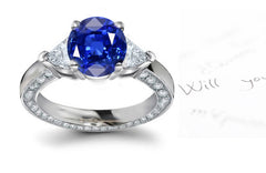 engagement ring with round blue sapphire center and diamond accents band