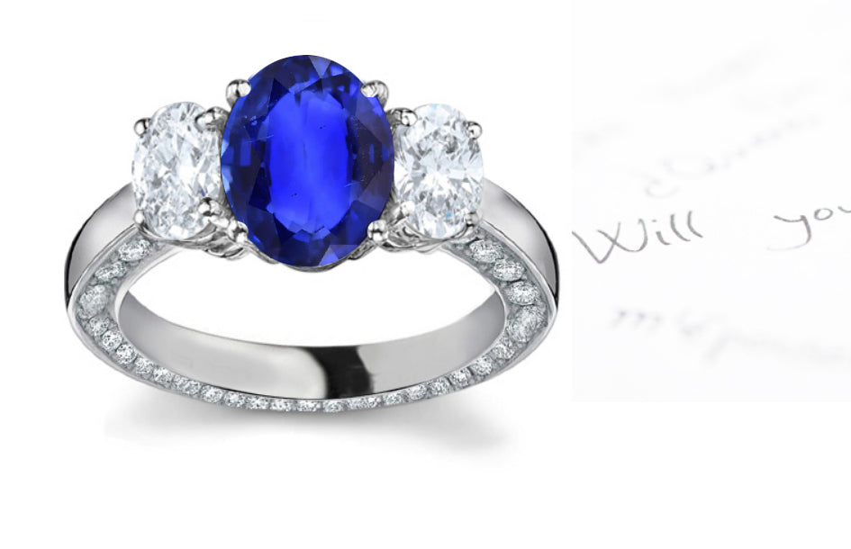 engagement ring three stone with oval blue sapphire center and side oval diamonds