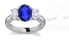 engagement ring three stone with oval blue sapphire center and side oval diamonds