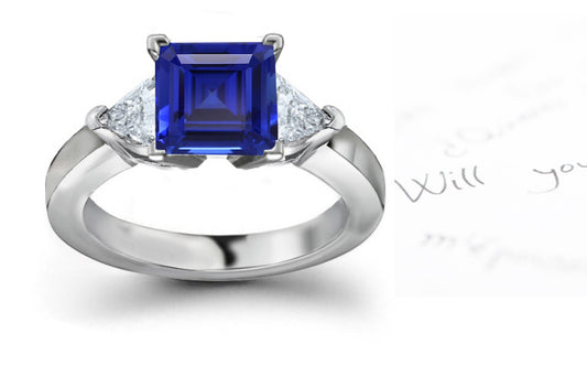 engagement ring with square blue sapphire center and side heart diamonds