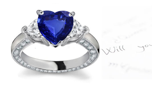 engagement ring handcrafted with heart blue sapphire center and side heart diamonds