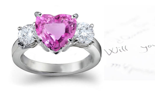 engagement ring with heart pink sapphire center and side round diamonds