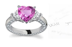 engagement ring handcrafted with heart pink sapphire center and side heart diamonds