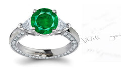 engagement ring with round emerald center and diamond accents band