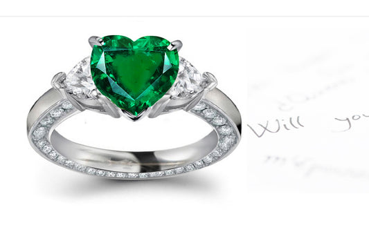 engagement ring handcrafted with heart emerald center and side heart diamonds