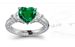 engagement ring handcrafted with heart emerald center and side heart diamonds