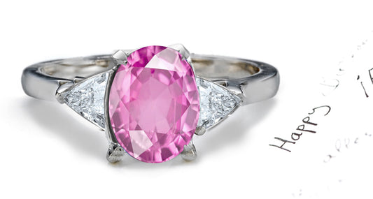 engagement ring three stone with oval pink sapphire and side trillion diamonds