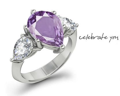 engagement ring with pear purple sapphire center stone and side pear diamonds