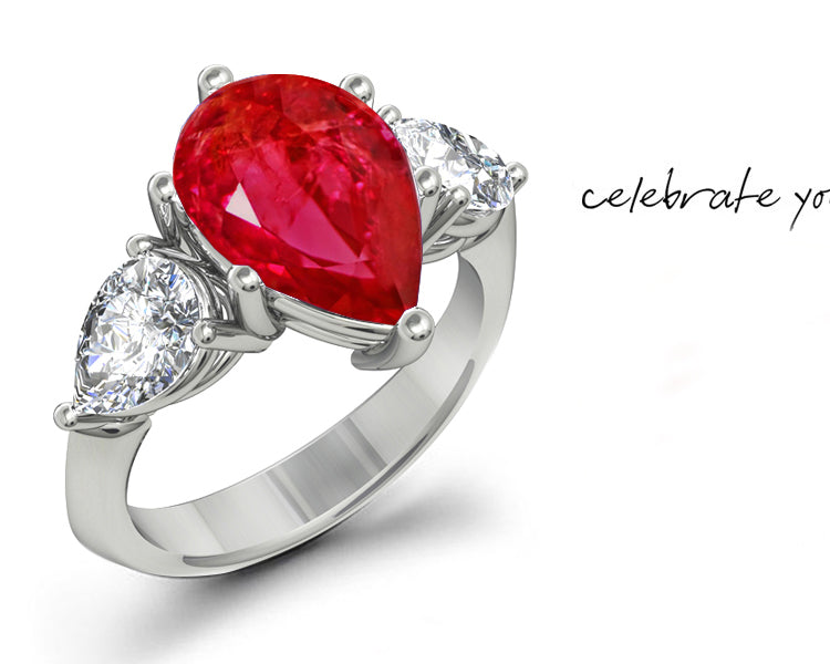 engagement ring three stone with pear ruby center and side pear diamonds