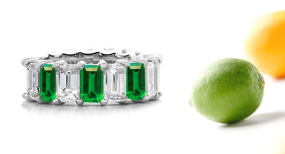 eternity ring prong set with emerald cut emeralds and diamonds