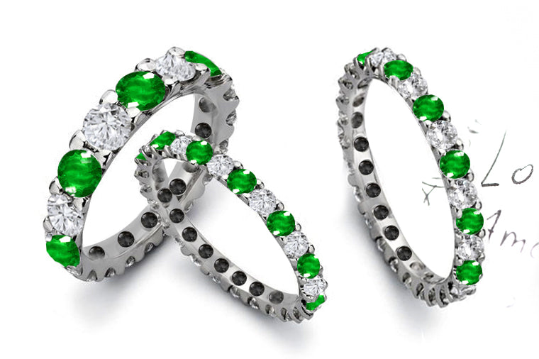 eternity ring prong set with round emeralds and diamonds